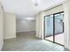 Spacious living room featuring tile floors, a modern light fixture, and a sliding glass door to the patio at 7484 Canford Ct # 8, Winter Park, FL 32792