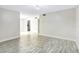 Bright living room featuring neutral walls, wood-look tile flooring, and modern lighting fixtures for a welcoming ambiance at 7484 Canford Ct # 8, Winter Park, FL 32792