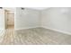 Open-concept living area featuring wood-look tile floors, neutral walls, and a view of the front entrance at 7484 Canford Ct # 8, Winter Park, FL 32792