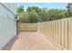 Private brick-paved patio area, enclosed by a wooden fence and the home's light stucco exterior at 7484 Canford Ct # 8, Winter Park, FL 32792