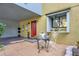 Cozy front patio with bistro set, plants, and attractive exterior at 7484 Canford Ct # 8, Winter Park, FL 32792