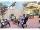 Charming brick patio with comfortable seating around a cozy fire pit at 7484 Canford Ct # 8, Winter Park, FL 32792