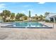 Sparkling community pool surrounded by tropical landscaping and lounge chairs at 7484 Canford Ct # 8, Winter Park, FL 32792
