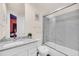 Well-lit bathroom featuring modern fixtures, granite countertops, and shower-tub combo at 7587 Sunflower Cir, Kissimmee, FL 34747