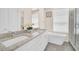 Elegant bathroom featuring double vanity with granite countertop, soaking tub, and glass-enclosed shower at 7587 Sunflower Cir, Kissimmee, FL 34747