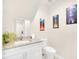 Bright bathroom featuring white cabinets, granite counters, and modern decor, creating a clean and inviting space at 7587 Sunflower Cir, Kissimmee, FL 34747