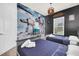 Themed bedroom with two beds, Star Wars wall art, and window providing natural light at 7587 Sunflower Cir, Kissimmee, FL 34747