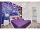 Stylized bedroom featuring playful decor, plush carpeting, and serene ambiance at 7587 Sunflower Cir, Kissimmee, FL 34747