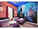 Themed bedroom with two beds, a brick-style accent wall, and a mural for a unique atmosphere at 7587 Sunflower Cir, Kissimmee, FL 34747