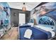 Themed bedroom featuring two twin beds, unique space-themed headboards, and a striking Star Wars mural at 7587 Sunflower Cir, Kissimmee, FL 34747