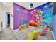 A vibrant themed bedroom with colorful decor, a mural, and fun furnishings, ideal for a room at 7587 Sunflower Cir, Kissimmee, FL 34747