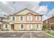 Charming two-story condo with designated handicap parking spots and white shutters at 7587 Sunflower Cir, Kissimmee, FL 34747