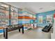 Fun game room with foosball table, TV, and colorful striped walls with comfortable seating at 7587 Sunflower Cir, Kissimmee, FL 34747