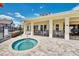 Outdoor hot tub near clubhouse with seating and landscaping and well-maintained brick patio at 7587 Sunflower Cir, Kissimmee, FL 34747
