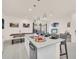 Open-concept kitchen with granite countertops, stainless steel appliances, and breakfast bar seating at 7587 Sunflower Cir, Kissimmee, FL 34747