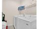 Functional laundry room equipped with modern washer and dryer for convenient chore management at 7587 Sunflower Cir, Kissimmee, FL 34747