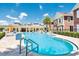 Inviting community pool with a view of the clubhouse and surrounding townhomes, great for recreation at 7587 Sunflower Cir, Kissimmee, FL 34747