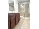 Bathroom with glass shower and brown cabinets at 7675 Fordson Ln, Windermere, FL 34786