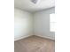 A cozy bedroom featuring neutral carpet, white walls, and a window for natural light at 7675 Fordson Ln, Windermere, FL 34786