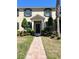 Charming townhome with a well-manicured lawn and a brick walkway leading to the front door at 7675 Fordson Ln, Windermere, FL 34786