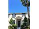Beautiful two-story townhome showcasing classic architectural details, landscaping and sunny blue sky at 7675 Fordson Ln, Windermere, FL 34786