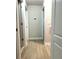 Hallway with wood floors showing doors, outlets and a thermostat at 7675 Fordson Ln, Windermere, FL 34786