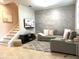 Comfortable living room with modern furniture, a cozy rug, and a stylish wood-look accent wall at 7675 Fordson Ln, Windermere, FL 34786