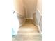A downward view of the staircase with light wood floors and white handrails at 7675 Fordson Ln, Windermere, FL 34786