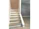 A staircase with wood grain-style flooring, white baseboards, and a gray accent wall at 7675 Fordson Ln, Windermere, FL 34786