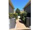 A brick walkway between two buildings is lined with manicured hedges and a clear sky above at 7675 Fordson Ln, Windermere, FL 34786