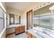 Bathroom with dual sinks, wood cabinets, and large mirror at 770 Manor Dr, Bartow, FL 33830
