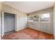 Bedroom with wood paneling, window, closet, and neutral carpeting at 770 Manor Dr, Bartow, FL 33830