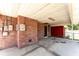 Covered carport featuring brick walls, concrete floors and access to the backyard at 770 Manor Dr, Bartow, FL 33830