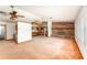Open-concept living room with brick fireplace, carpet, and bright interior at 770 Manor Dr, Bartow, FL 33830