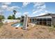 Backyard pool with slide, concrete deck and fenced in yard at 770 Manor Dr, Bartow, FL 33830