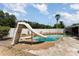 Backyard pool with slide, concrete deck and fenced in yard at 770 Manor Dr, Bartow, FL 33830