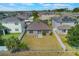 Aerial view of home with large backyard, surrounded by a white fence and lush greenery at 902 Grand Hilltop Dr, Apopka, FL 32703