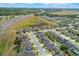 This aerial shot showcases a well-planned neighborhood next to a highway and a natural wetland area at 902 Grand Hilltop Dr, Apopka, FL 32703