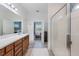 Bright bathroom with a large vanity, and glass door shower, all connected to a large bedroom at 902 Grand Hilltop Dr, Apopka, FL 32703