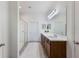 Bright bathroom with a long vanity, double sinks, and glass door shower at 902 Grand Hilltop Dr, Apopka, FL 32703