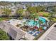 Aerial view of a community pool featuring palm trees, lounge chairs, and ample seating areas at 902 Grand Hilltop Dr, Apopka, FL 32703