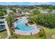 Aerial view of the community pool, featuring a resort-style pool with lounge chairs and lush landscaping at 902 Grand Hilltop Dr, Apopka, FL 32703