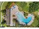 Aerial view of a community pool featuring sun loungers, palm trees, and a splash pad for  at 902 Grand Hilltop Dr, Apopka, FL 32703