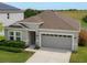 Charming single-Gathering home featuring a two-car garage and well-maintained lawn at 902 Grand Hilltop Dr, Apopka, FL 32703