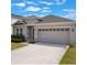 Charming single-Gathering home features a well-maintained lawn, a neutral color palette, and a two-car garage at 902 Grand Hilltop Dr, Apopka, FL 32703