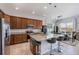 Open-concept kitchen with granite countertops, stainless steel appliances, and an island with seating at 902 Grand Hilltop Dr, Apopka, FL 32703