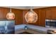 Pendant lights hanging above an island with a sink, complementing the stainless steel appliances and cabinets in the kitchen at 902 Grand Hilltop Dr, Apopka, FL 32703