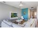 Bright living room featuring a sectional sofa, modern entertainment unit, and stylish accents at 902 Grand Hilltop Dr, Apopka, FL 32703