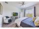 Main bedroom featuring a large window and a decorative chair, creating a relaxing and well-lit space at 902 Grand Hilltop Dr, Apopka, FL 32703