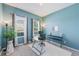 Lovely home office with a nice desk, white rug, and bright blue paint at 902 Grand Hilltop Dr, Apopka, FL 32703